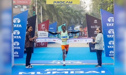 Ethiopias tadu abate deme crossed the finish line to win the overall mens title at the tata mumbai m.jpeg